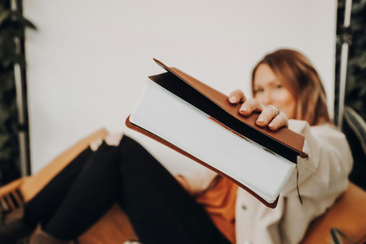 Lady holding up a bible.