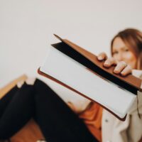 Lady holding up a bible.