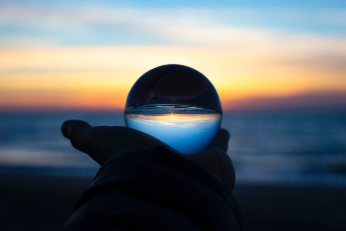 Hand holding glass ball